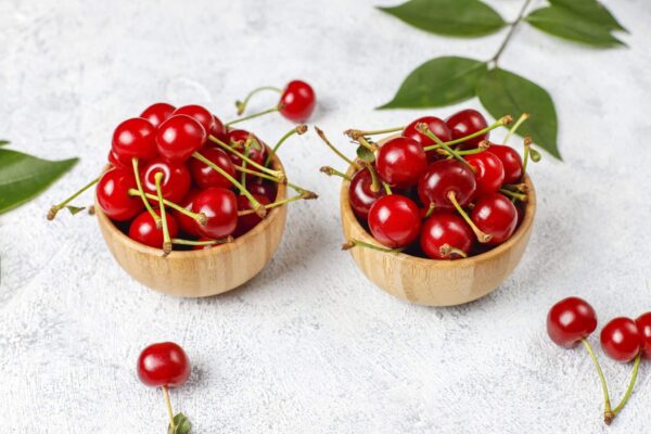 red cherries plate bowl gray table scaled 1